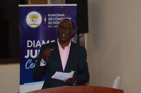 Head Teacher Bbale David speaks at the fundraising dinner.