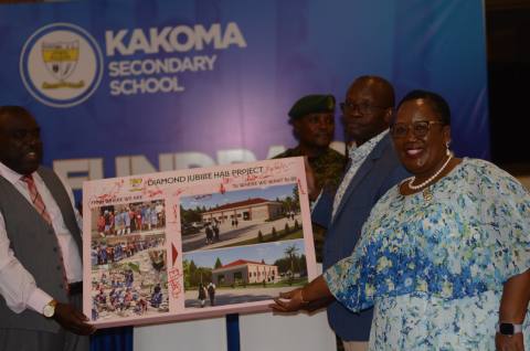 The Diamond Jubilee Hall Project proposal is presented to the Board Chairman, Head Teacher and guests for signing and pledges.
